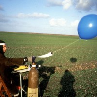 MEASURABLE LOSS OF WATER DURING A BIRDS' FLIGHT_______typing about water loss in a reclaimed landscape, littered with sea shells. the text send skyward with a helium balloon / Flevoland Netherlands / 1994