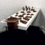 CHOCOLATE SOLILOQUY_______chocolate fetal goat casts, dried goat ears, alarm clock dipped in chocolate / 1989